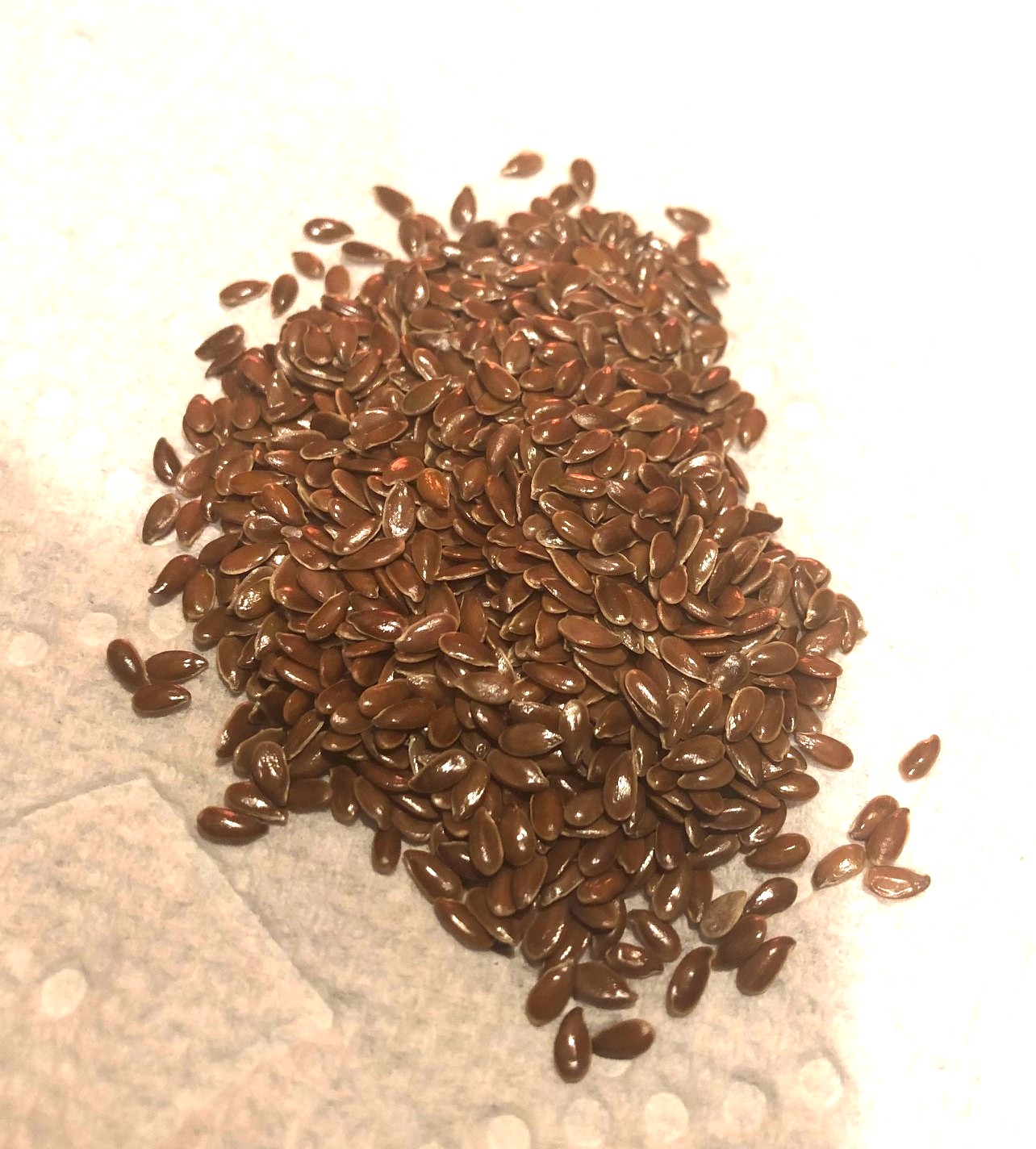 Organic Brown Flax Seeds on White Background