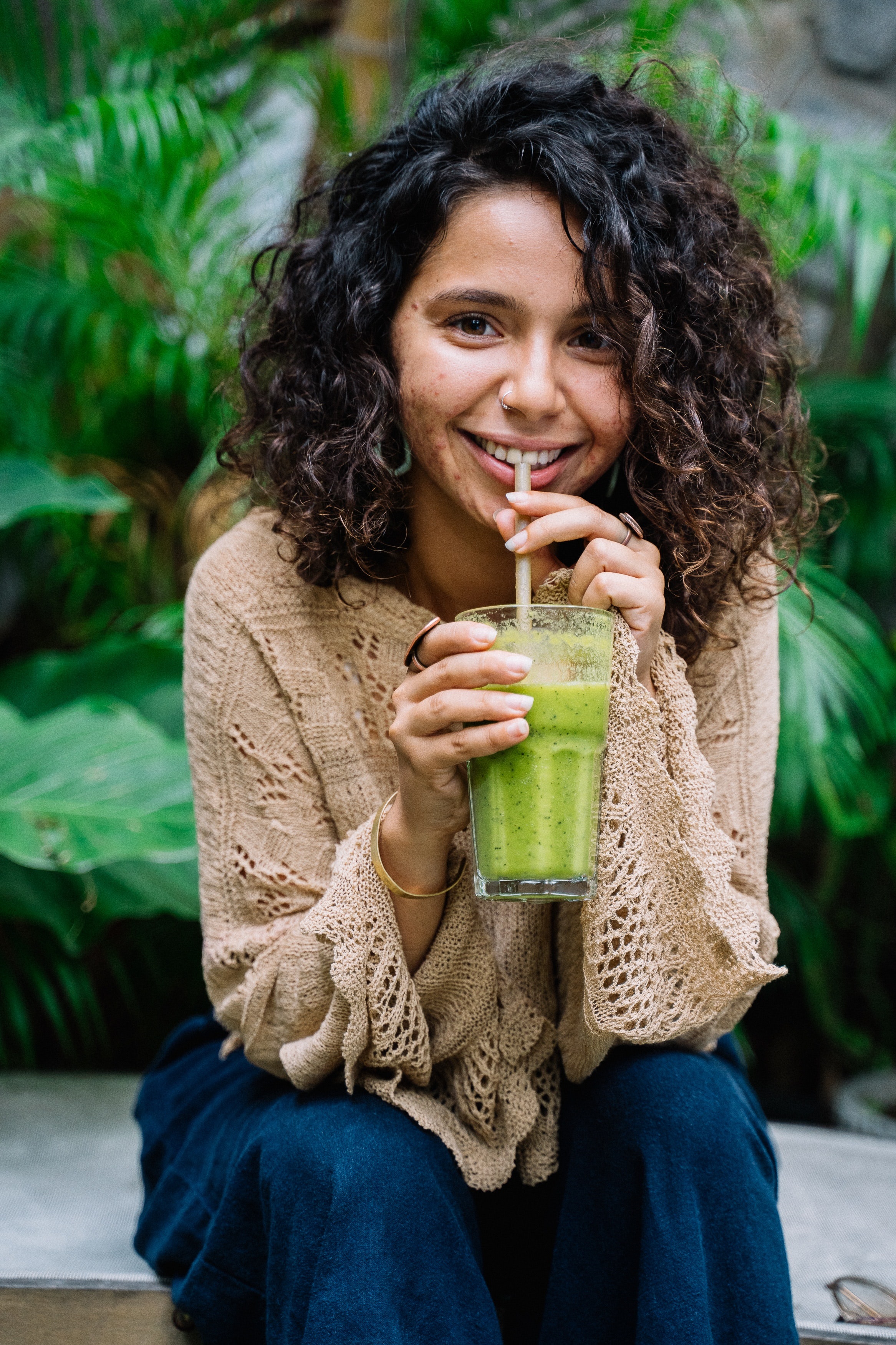 You Woman with Healthy Hair Sipping a Green Detox Smoothie