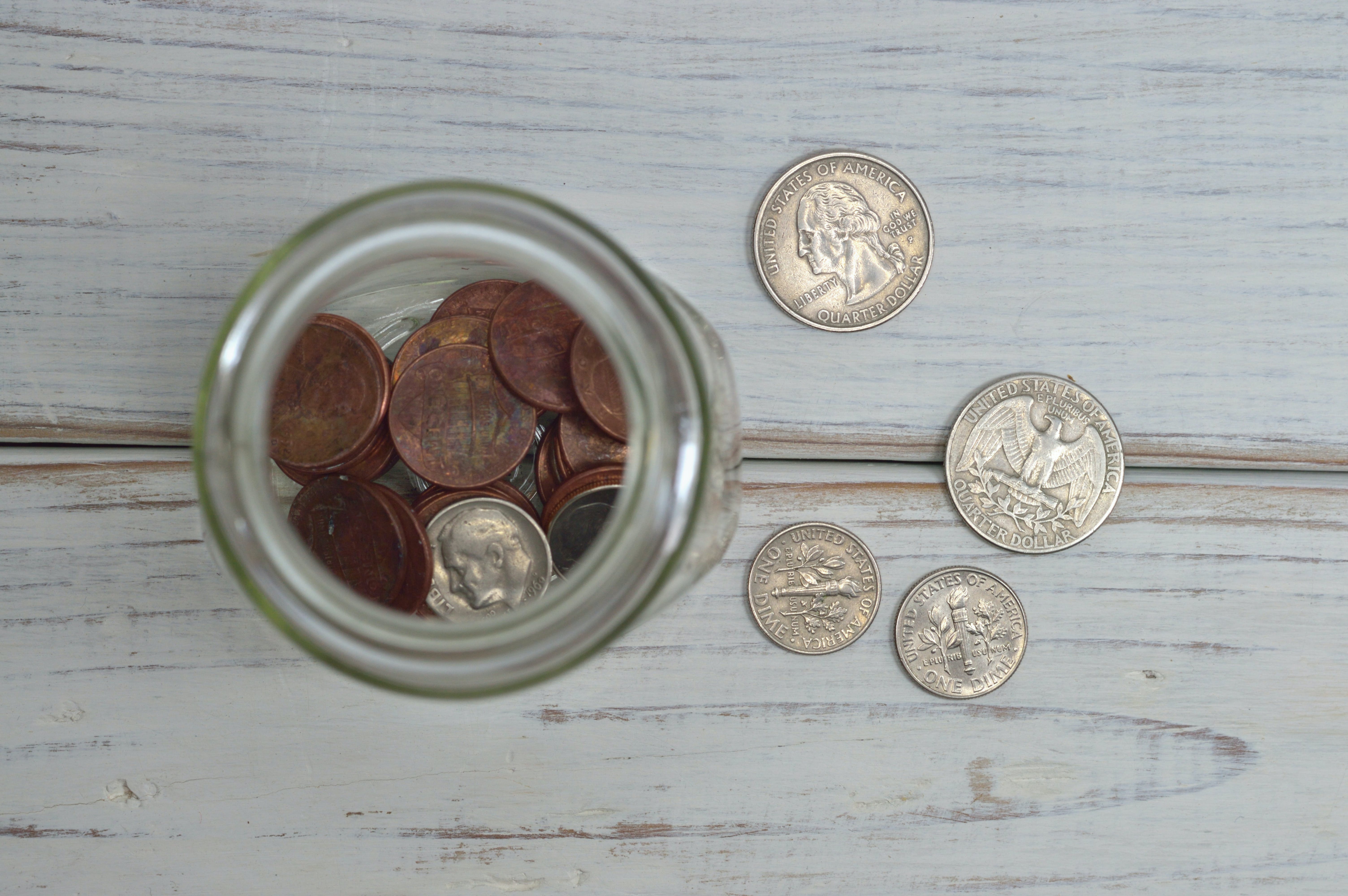 Money - Pennies - Nickels - Dimes on White Driftwood Background